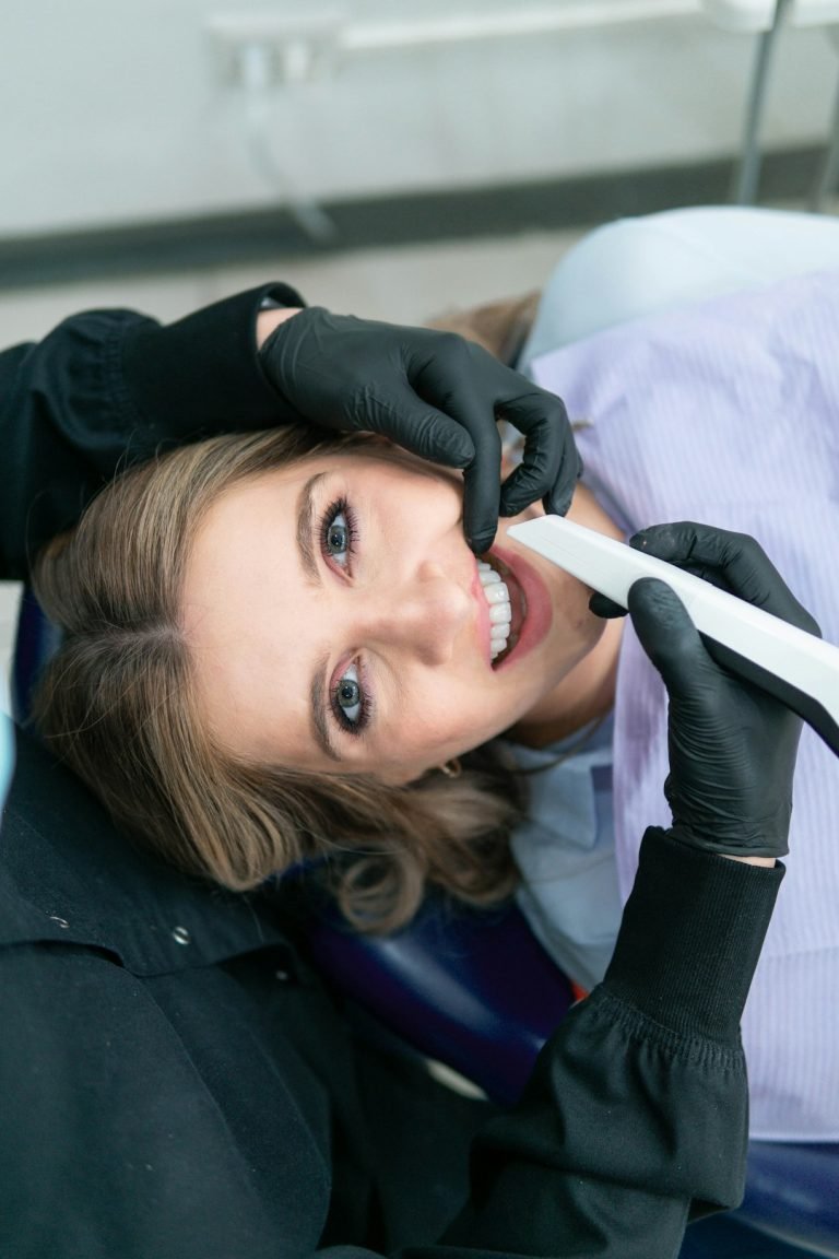 a-woman-is-smiling-while-holding-a-toothbrush-47fkvu4nimk